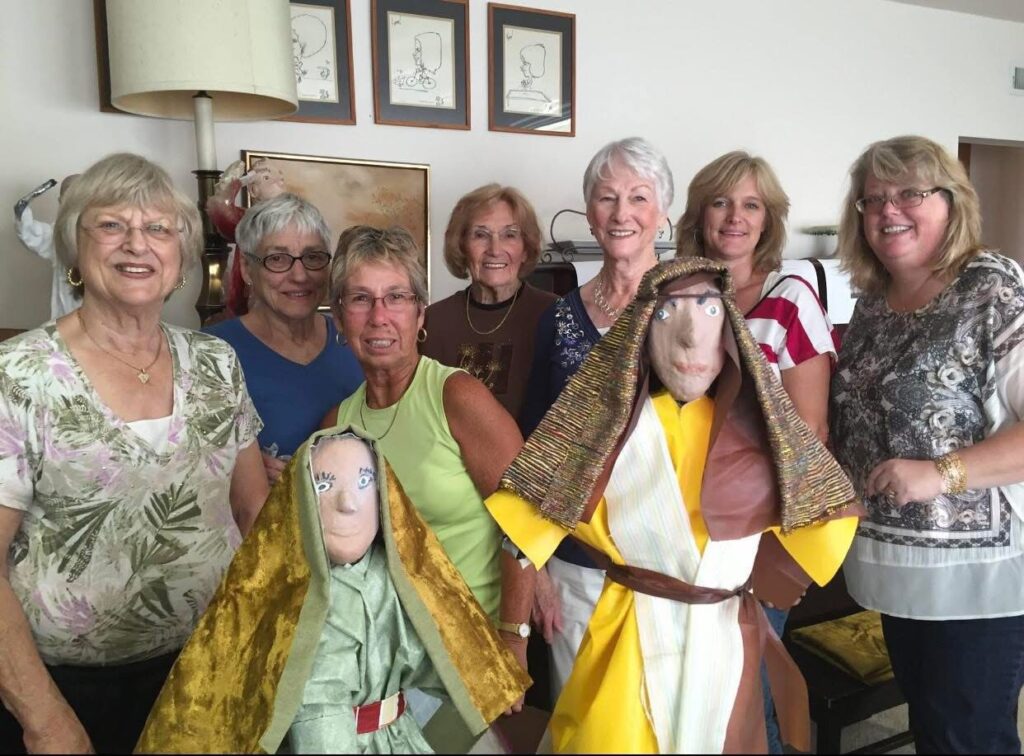 jane bartke and her friends and daughters posing for a photo with display figures
