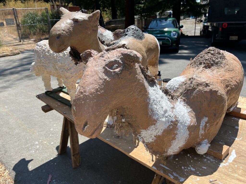 camel figures drying in the sun after repairs