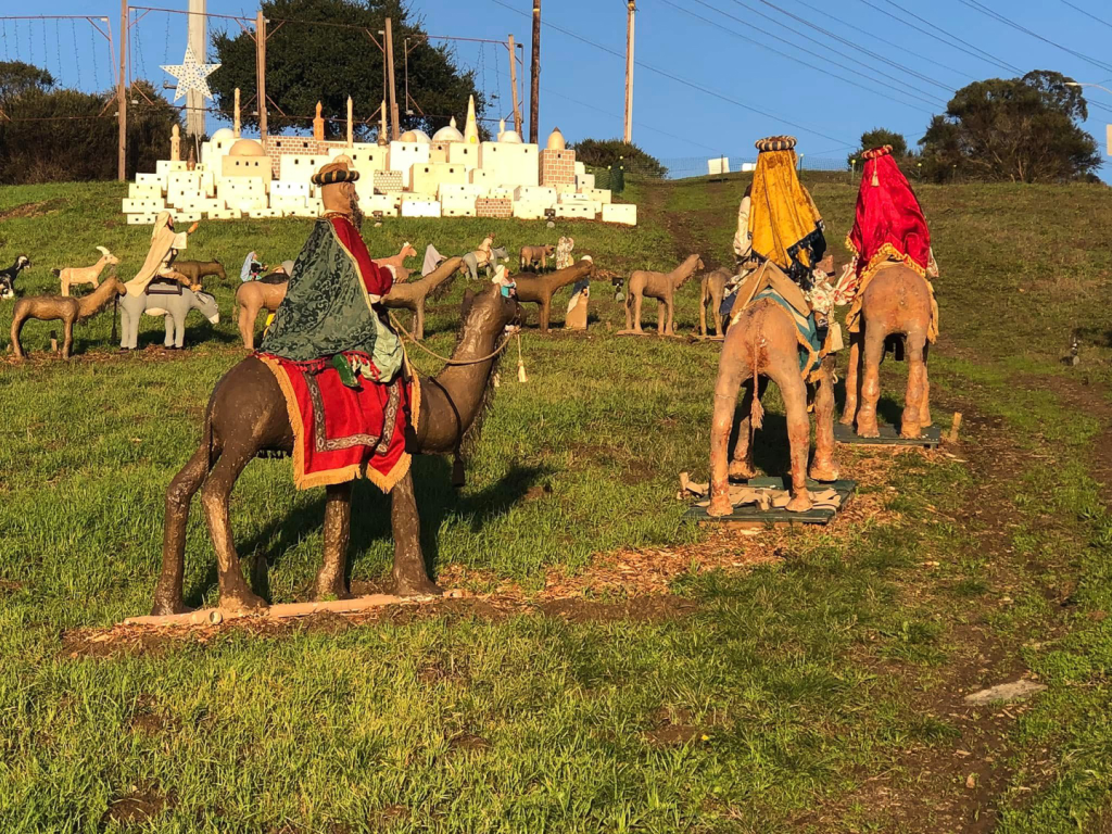 the three kings on camels in front of the display