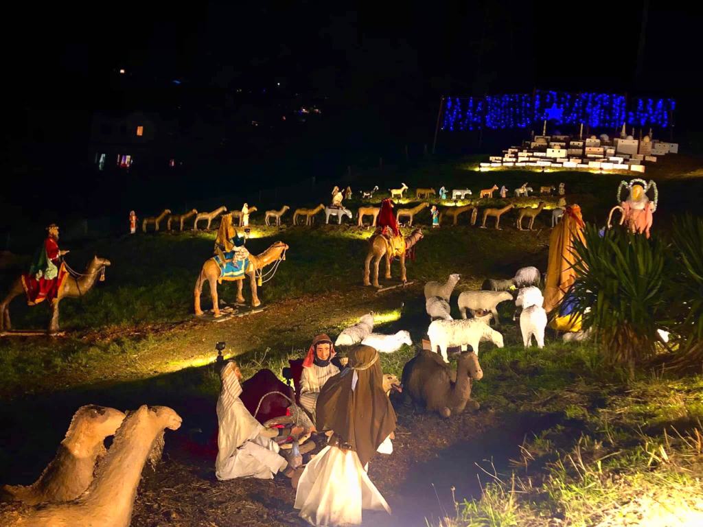 display at night with campfire figures in front