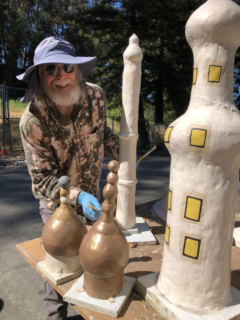 volunteer repainting bethlehem figure
