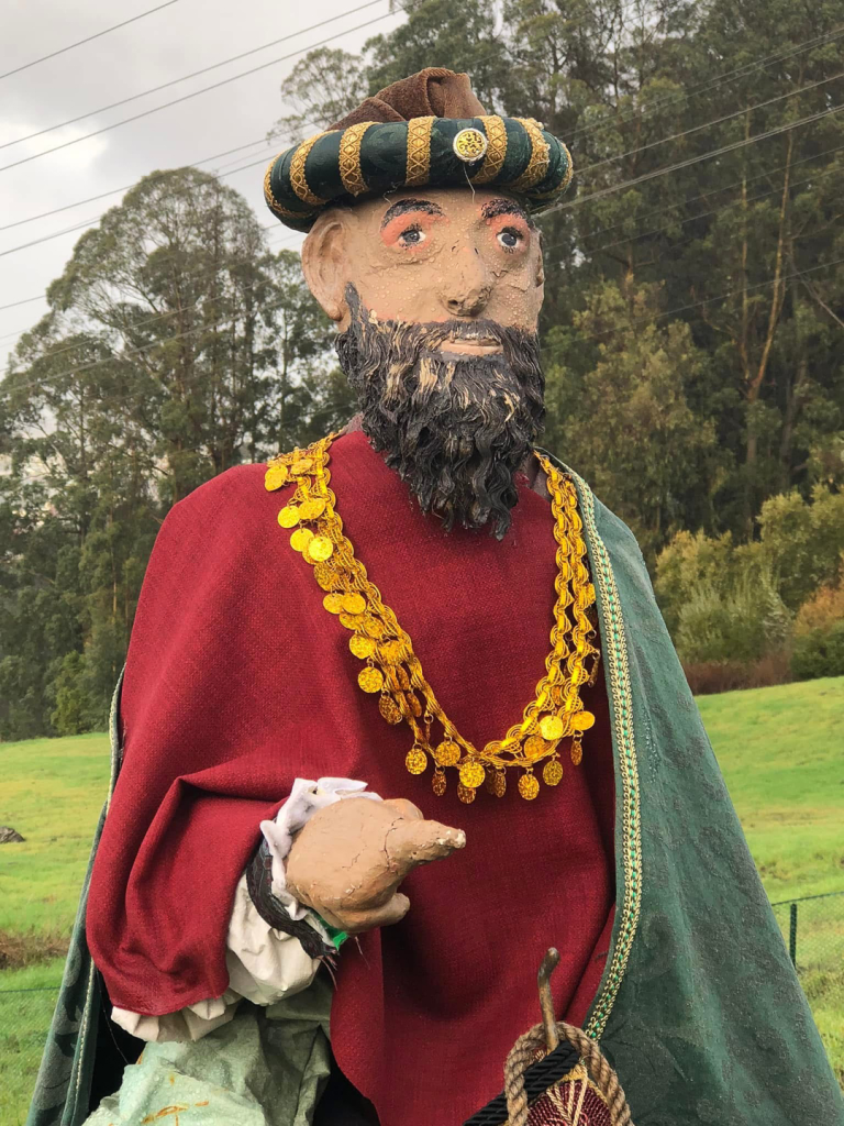 front view of wise man figure in red and green robes