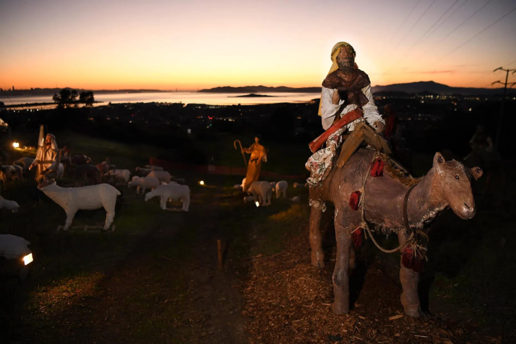 wise man figure on camel figure at sunset with san francisco bay and el cerrito in the back