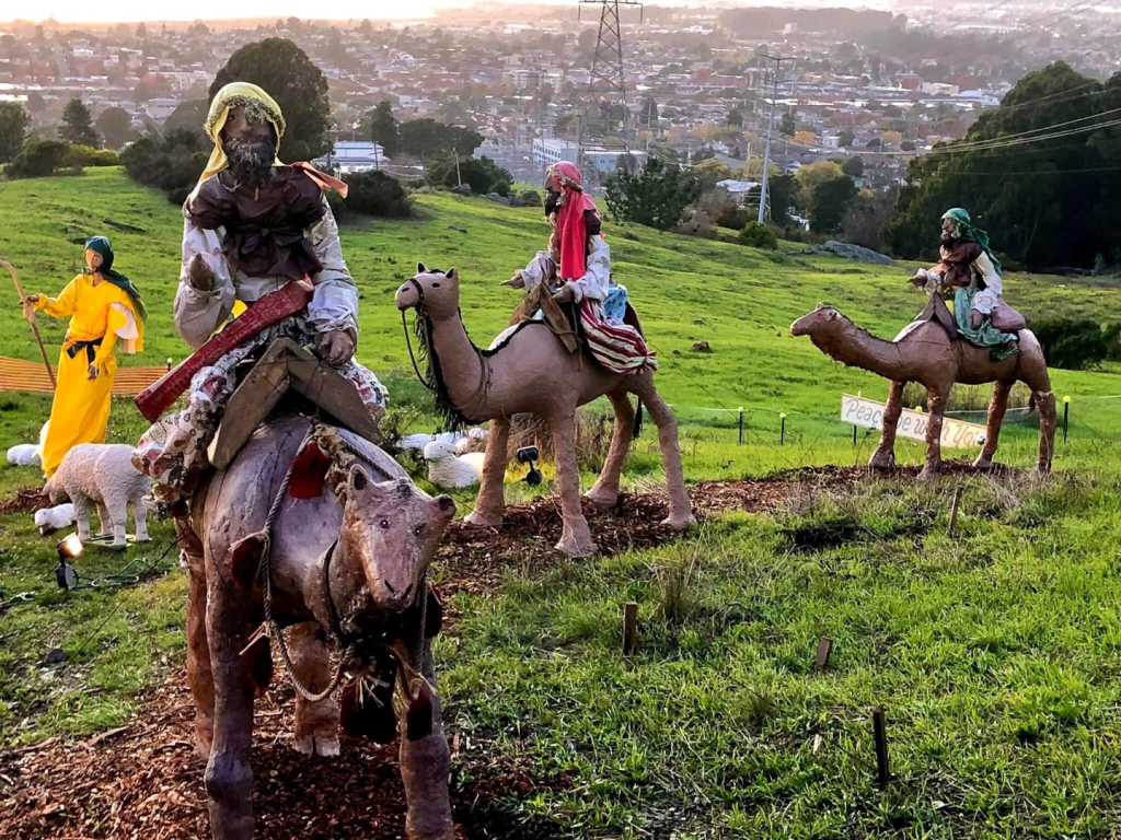three wise men figures with el cerrito in the background